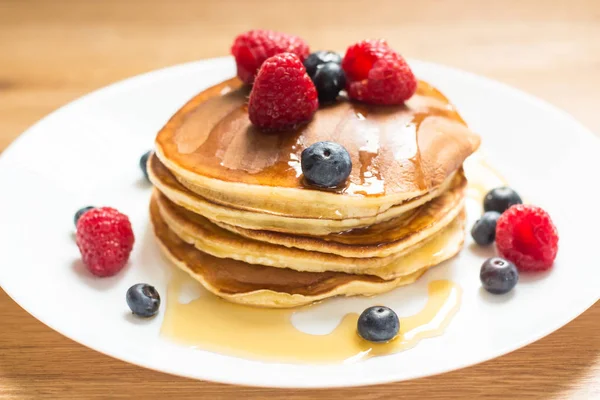 Breakfast. Berries. Pancakes. Romantic breakfast on a wooden table. Spring morning. Cozy.