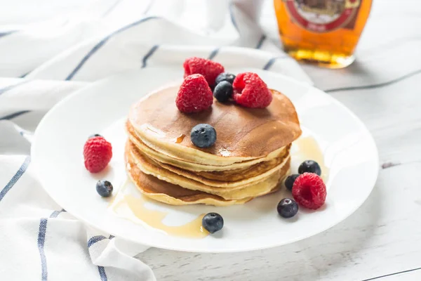 Breakfast. Berries. Pancakes. Romantic breakfast on a wooden table. Spring morning. Cozy.