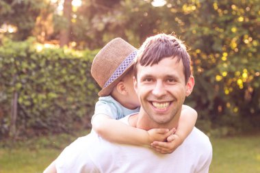 Baba ve oğul günbatımında yürümek. Mutlu baba ve oğlunun güneşin.