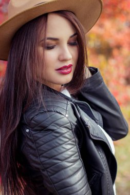 Şapkasını ve ceket sonbahar Park genç güzel kadın. Sıcak sonbahar. Mutlu kız sonbahar portresi. Mutlu genç kadın walkin