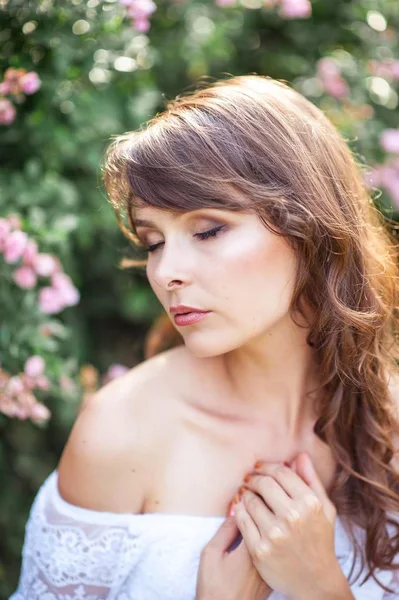 Jeune belle femme se promène dans le parc fleuri. Portrait d'une jeune femme. Bonne fille. Été . — Photo