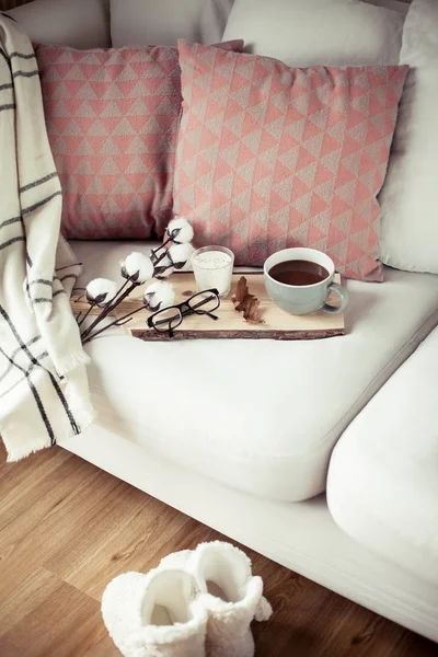 Autumn cozy breakfast. Romantic breakfast. Cotton, a cup of hot coffee, a candle, a plaid, glasses. Autumn cosiness. A tray with