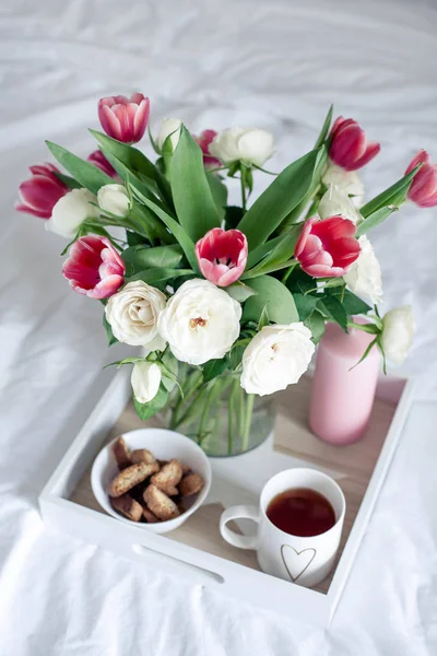 Romantic breakfast in bed. Bouquet of flowers. Roses and tulips. Spring. Valentine\'s Day. International Women\'s Day. Cozy.