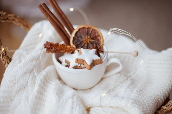 Wicker basket, knitted sweater, dried citruses, cinnamon sticks, Christmas cookies, Christmas lights. Cozy. — 스톡 사진