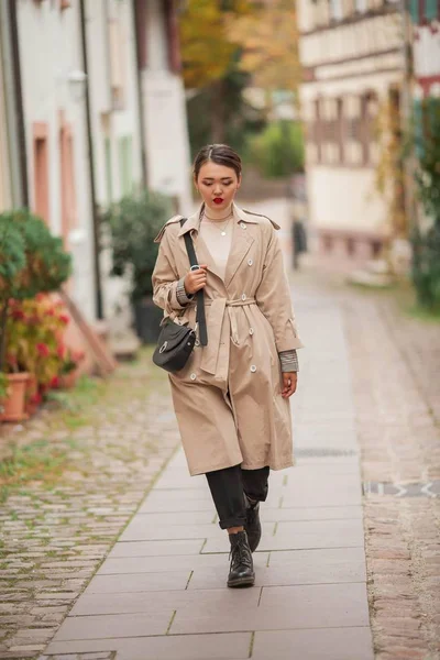 Une belle jeune femme asiatique se promène dans une ville européenne. Portrait à la mode d'une jeune asiatique. Blogueur . — Photo