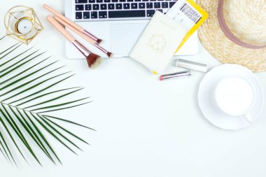 Tropical plant, women's straw hat, cappuccino mug, plane ticket, passport on a white background. Women's things.