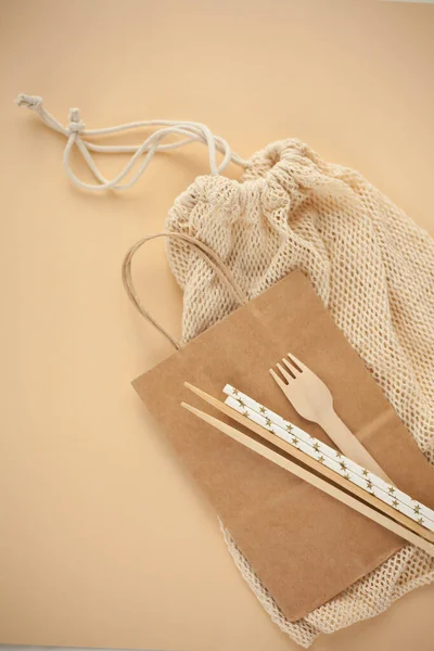 Natural eco accessories for life. A paper bag, bamboo sticks, paper tubes, a bag made of thread. Eco.