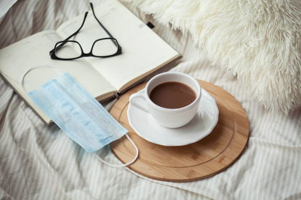 Cup Hot Cocoa Croissant Wooden Stand Medical Mask Notebook Glasses — Stock Photo, Image