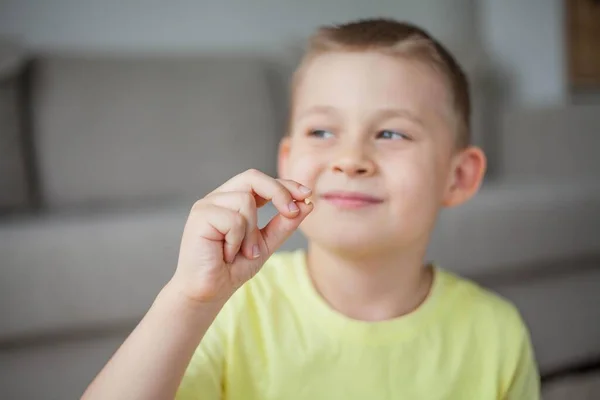 A criança deixou cair o primeiro dente de leite. Menino feliz e dente de leite. — Fotografia de Stock