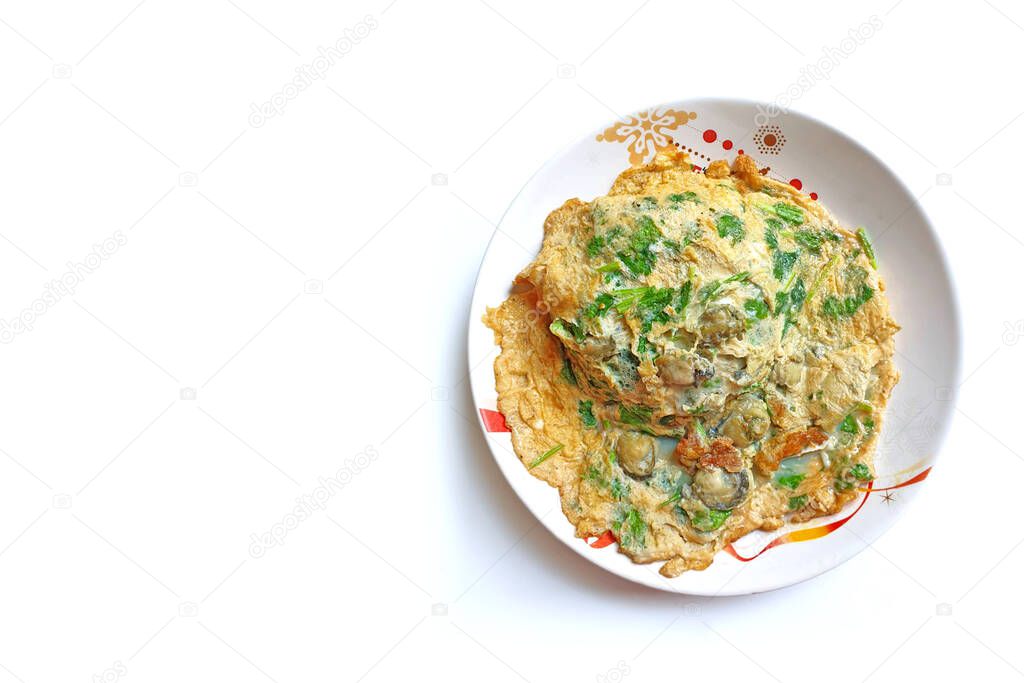 Oyster omelet, put coriander on top of a white plate, top view.