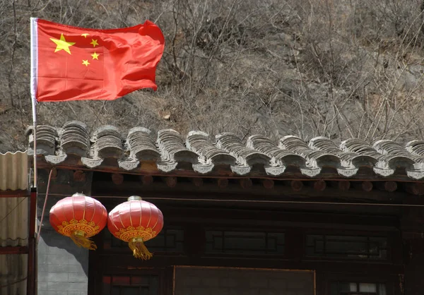 Chinese flag and red lanterns in Cuandixia (Chuandixia), an ancient town or village near Beijing, China. Cuandixia is a Ming Dynasty town. Chuandixia has Ming / Qing Dynasty architecture. Chinese flag