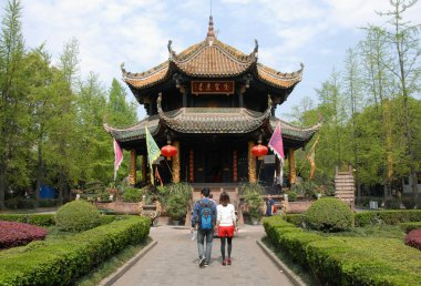 Eight Trigrams Pavillion at the Green Ram Temple or Green Goat Temple in Chengdu China with visitors. It's also known as the Green Ram or Goat Monastery. It's a Chinese Taoist temple with religious signs in Chinese clipart