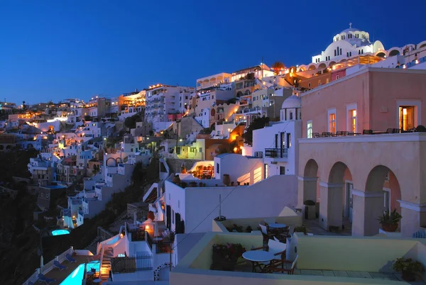 Evening view of Fira on the island of Santorini, Greece. Fira is the main town of Santorini. Santorini has many colorful houses. Pretty Fira, Santorini, Greece at night with town, houses and lights.