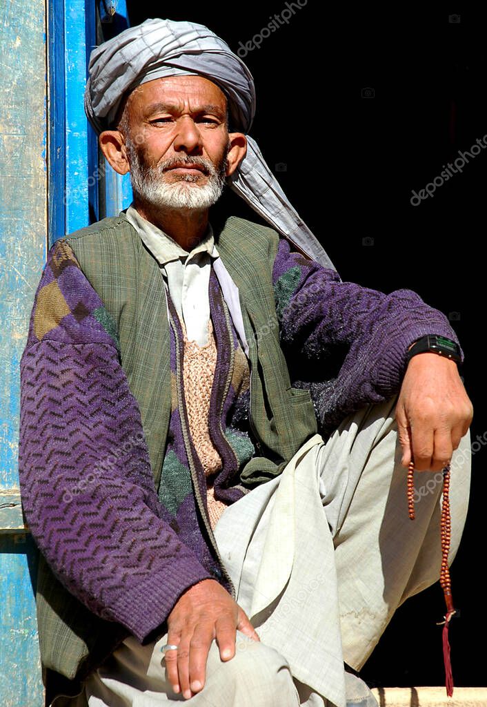 Syadara Siyah Darah In Bamyan Bamiyan Province Afghanistan An Afghan Man Sits In A Doorway In The Small Town Of Syadara In Central Afghanistan Man With Turban And String Of Beads 356844780