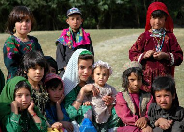 A small village between Chaghcharan and the Minaret of Jam, Ghor Province in Afghanistan. A large group of children pose for a photograph in a remote part of Central Afghanistan. clipart