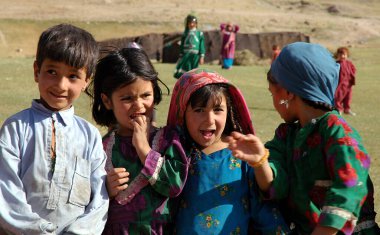 A small village between Chaghcharan and the Minaret of Jam in Ghor Province, Afghanistan. A group of Afghan children are photographed in a field in a remote part of Central Afghanistan. clipart