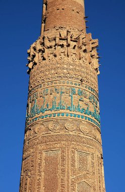 Minaret of Jam, Ghor Province in Afghanistan. The Jam minaret is a UNESCO site in a remote part of Central Afghanistan. The Minaret of Jam showing detail of the kufic inscription in turquoise tiles. clipart