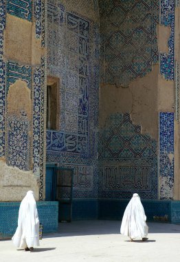 Afganistan 'ın Balkh kentindeki Khwaja Abu Nasr Parsa Tapınağı' nda (Yeşil Cami) iki kadın burka giyiyor. Tapınak mozaikler ve biçimlendirilmiş Kuran el yazısıyla süslenmiş. Afganistan 'daki camii.