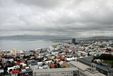 Reykjavik, İzlanda 'daki Hallgrimskirkja. Hallgrimskirkja, İzlanda 'nın en büyük kilisesidir ve Reykjavik' in önemli bir simgesidir. Reykjavik şehir merkezi, kilise kulesinin tepesinden görünüyor..
