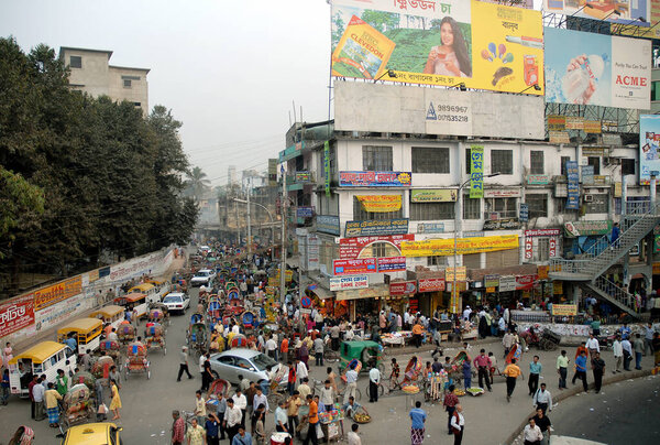 Dhaka in Bangladesh. A crowd of people and transport on the street in the Farmgate area of Dhaka, Bangladesh. This is a typical local life scene in Dhaka, the capital city of Bangladesh.
