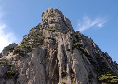 Huangshan Dağı, Anhui Eyaleti, Çin. Lotus Tepesi 'nin zirvesi, Huangshan' ın en yüksek noktası. Uçurumların manzarası, çam ağaçları ve Çin 'deki Huangshan Dağı' nın zirve yolu..