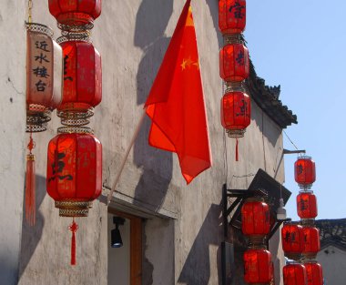 Anhui Eyaleti, Çin 'deki Hongcun Antik Kasabası. Geleneksel binanın dışında kırmızı fenerler ve Hong Kong 'da Çin bayrağı var. Çin 'in antik Hongcun şehrinin tarihi mimarisi.
