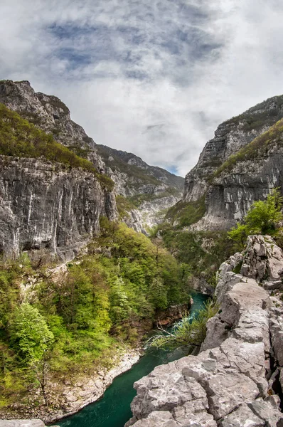 River in the canyon. The Tara river. Steep stone banks do not often allow you to approach the unusual turquoise water of the river. Montenegro.