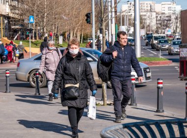 Bükreş / Romanya - 03.17.2020: Coronavirus 'tan korunmak için yüz maskesi takan kadın.