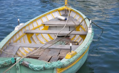 Akdeniz 'de eski bir beyaz ve turkuaz ahşap kayık iskelesi boş. Malta sahillerinde bulunan tipik küçük tekne..