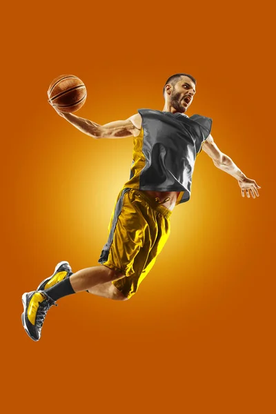 Bright professional basketball player on an orange background — 图库照片