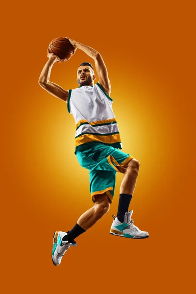 Bright professional basketball player on an orange background — Φωτογραφία Αρχείου