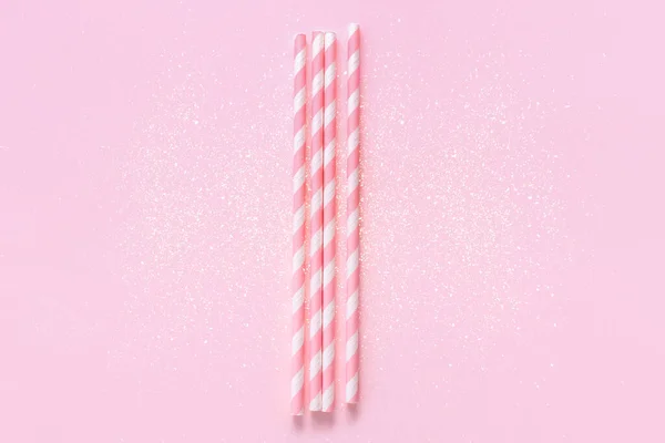 Straws on background with sparkles