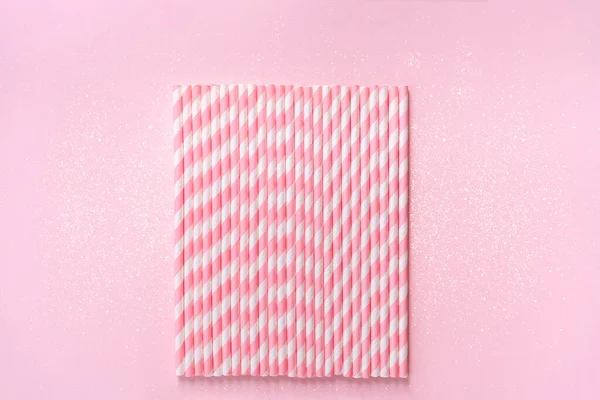 Straws on background with sparkles