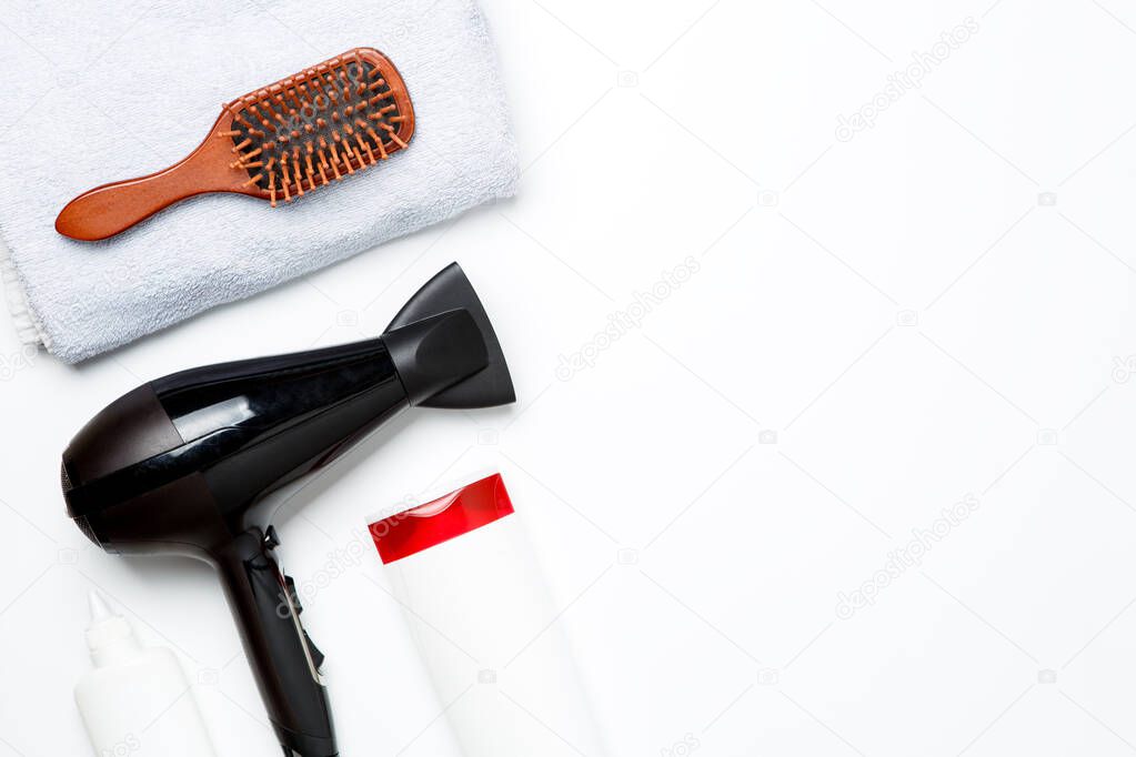 Photo of hair dryer, comb, scissors, towels, soaps isolated on white background. Empty space for text on side