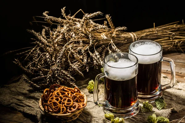 Two Tankard Beer Wheat Hops Basket Pretzels Wooden Table — Stock Photo, Image