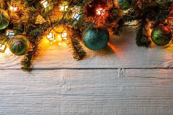 Photo Fir Branches Christmas Balls Burning Garland White Table — Stock Photo, Image