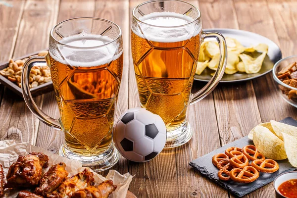 Appetizers and beer on the table for the football party and watch the football match.