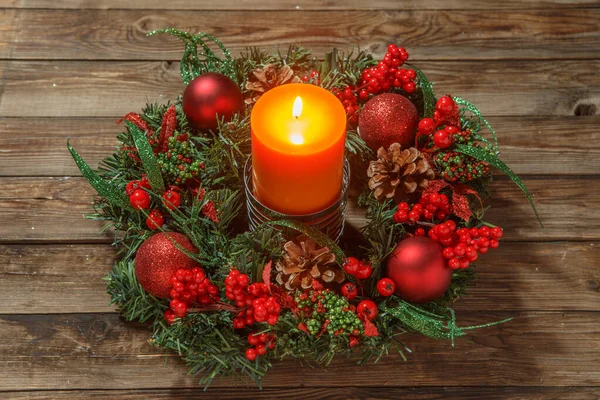 Advent wreath with candle on wooden table. Christmas time.