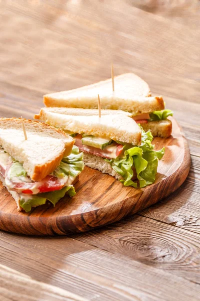 Imagen Sándwiches Con Palillos Dientes Verduras Frescas Sobre Tabla Madera — Foto de Stock