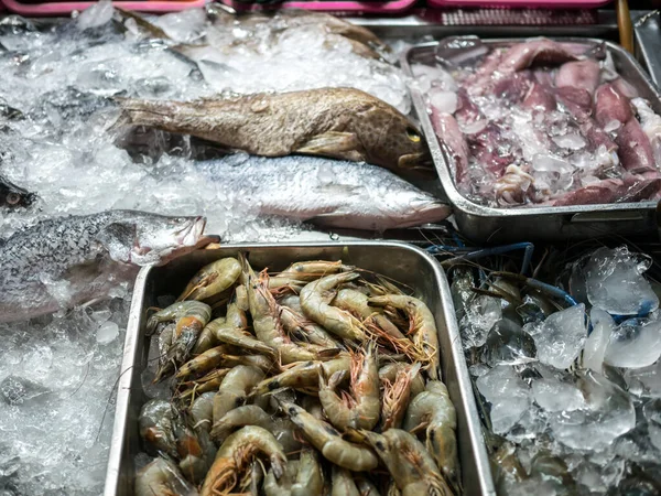 Outdoor store selling fresh seafood in ice