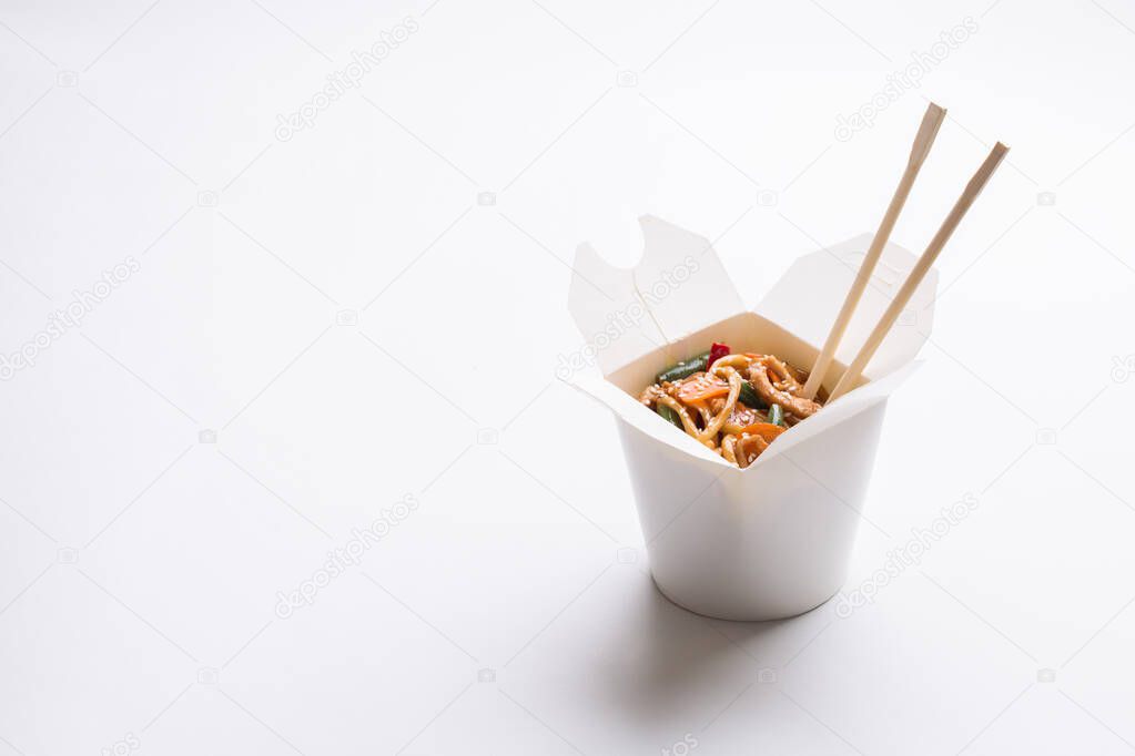 Chinese noodles in white box on isolated background