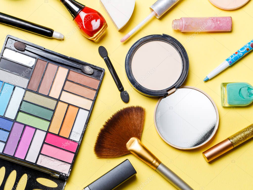 Photo on top of different cosmetics on yellow background