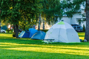 Ağaçları ve yeşil otları olan güzel doğal yerlerdeki çadır alanları.