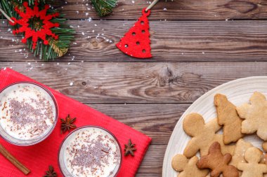 Noel 'de eggnog, kurabiyeler ahşap masada kırmızı peçete