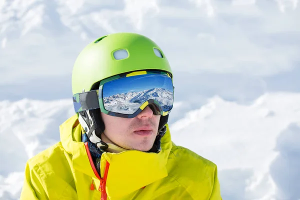 在雪山景观的背景下 运动员戴着面具和头盔站在一边的形象 — 图库照片