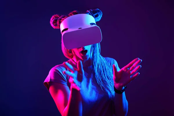 A nő virtuális valóság headsetet használ. Neon light stúdió portré. — Stock Fotó