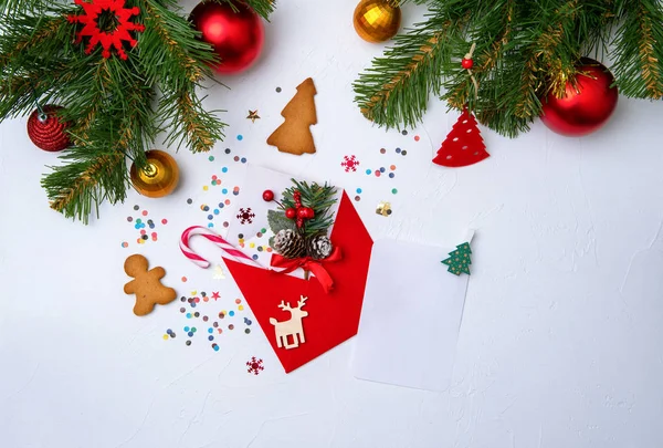 Foto von rotem Umschlag, Plätzchen, Zweigen von Fichtenweihnachtsdekoration. — Stockfoto