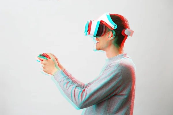 Man with virtual reality headset is playing game. Image with glitch effect. — Stock Photo, Image