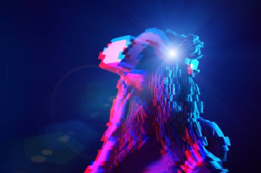 Woman is using virtual reality headset. Neon light studio portrait. Image with glitch effect.