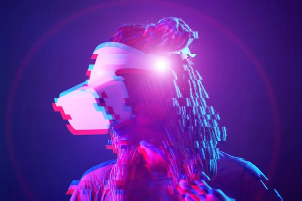 Woman is using virtual reality headset. Neon light studio portrait. Image with glitch effect. — Stockfoto